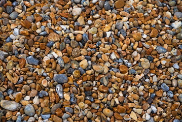 Brown and grey pebbles on the seaside.