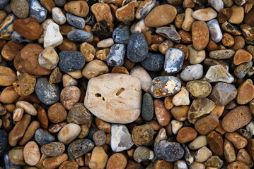 Brown and grey pebbles on the seaside.