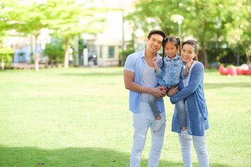 Happy asian family together with daughter in park