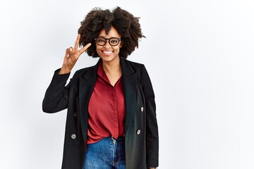 African american woman with afro hair wearing business jacket and glasses smiling looking to the camera showing fingers doing victory sign. number two.