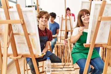 Group of young draw students smiling happy drawing at art studio.