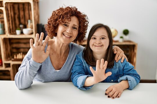 Mature mother and down syndrome daughter at home taking a picture