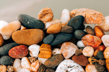Colorful sea pebbles close-up. Background texture, sea stones in the water