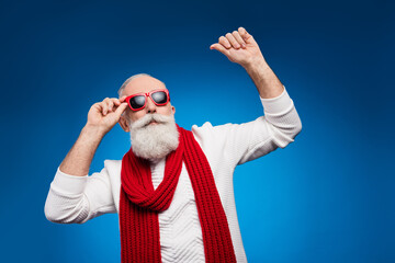 Photo of funky charming age gentleman wear white sweater red eyewear smiling dancing isolated blue color background