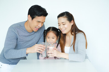 Asian family drinking water with together