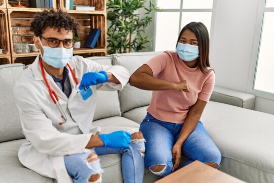 Doctor Man And Patient Woman Bump Elbow As A Protection Covid-19 Handshake.