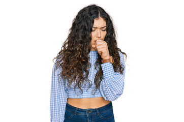 Young hispanic girl wearing casual clothes feeling unwell and coughing as symptom for cold or...
