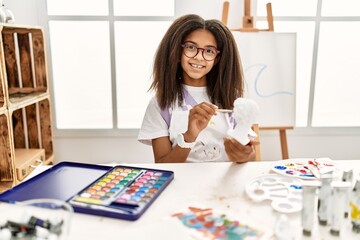 Fototapeta premium African american girl smiling confident drawing sculpture at art school