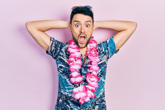 Young hispanic man wearing summer style afraid and shocked with surprise and amazed expression, fear and excited face.