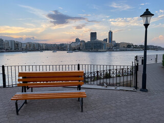 Bench at Independence Garden overlooking Saint Julian's Bay and San Giljan (Saint Julian's).