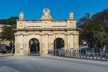 Fototapeta na wymiar Originally built in 1721 as a gate in the Floriana Lines, the Portes des Bombes now looks like a triumphal arch since the ramparts on either side were demolished.