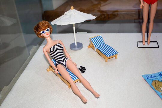 Vintage Bubrby doll in striped swimsuit on deck chair. Exhibition at the Titiqaqa Museum - Russia, St. Petersburg, August 2020