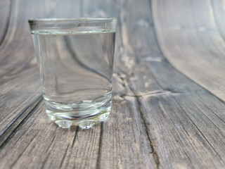 The shot of vodka close-up. Transparent alcoholic drink in glass.