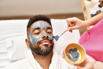 Man reciving facial treatment at beauty center. - Powered by Adobe