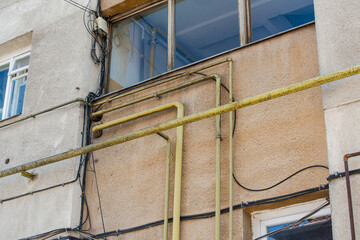 Yellow gas pipe connections on old apartment building.