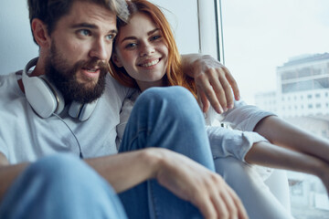 Man and woman sitting on the windowsill together apartments