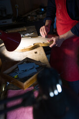 luthier while working on the creation of a violin