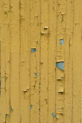 Old wooden wall with yellow paint, background texture