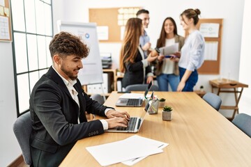 Young business worker smiling happy working while partners have break time at the office.
