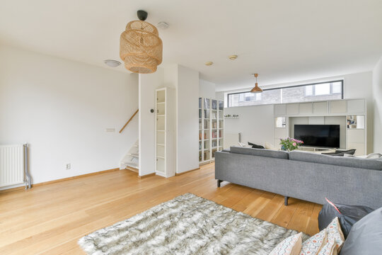Modern room interior with sofa against flowers on table