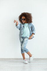 Beautiful stylish little girl in denim clothes