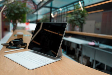 freelancer's workplace. A thin mobile laptop on a table in a coworking