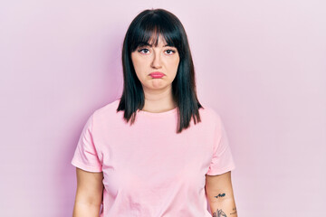Obraz premium Young hispanic woman wearing casual clothes looking sleepy and tired, exhausted for fatigue and hangover, lazy eyes in the morning.