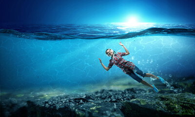 Obraz na płótnie Canvas Woman wearing headphones underwater . Mixed media