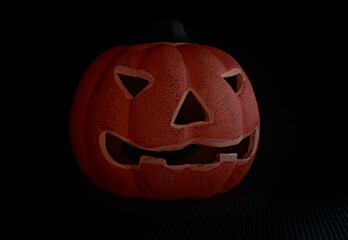 A carved pumpkin in a black background - halloween concept