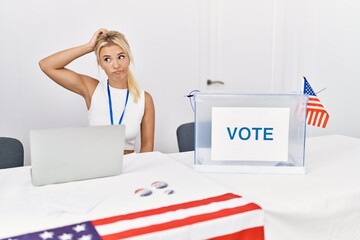 Young caucasian woman at america political campaign election confuse and wondering about question. uncertain with doubt, thinking with hand on head. pensive concept.