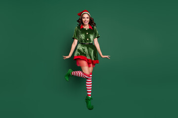 Full length body size view of attractive cheerful funny girl elf jumping having fun isolated over...