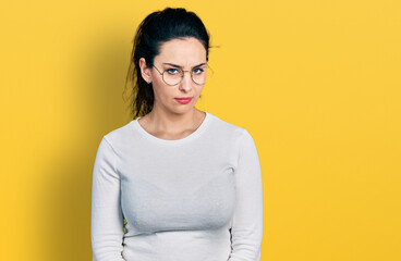Young hispanic woman wearing casual clothes skeptic and nervous, frowning upset because of problem....
