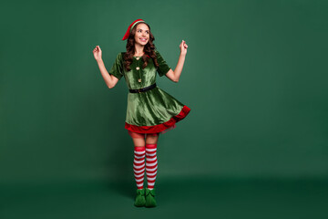 Full length body size view of attractive cheerful girl elf posing having fun eve day isolated over green color background - obrazy, fototapety, plakaty