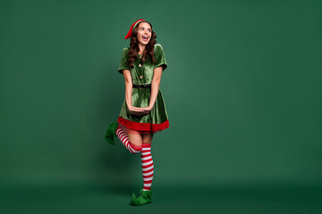 Full length body size view of attractive funky cheerful girl elf dancing posing having fun isolated over green color background - obrazy, fototapety, plakaty