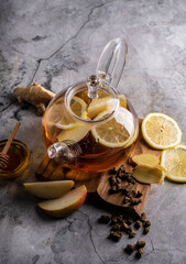 selective focus, freshly brewed tea in a transparent teapot, with fruits and fresh berries. leaf...