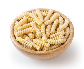 Uncooked fusilli corti bucati pasta in wooden bowl isolated on white background with clipping path