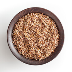 Grains of spelt in ceramic bowl isolated on white background wiht clipping path
