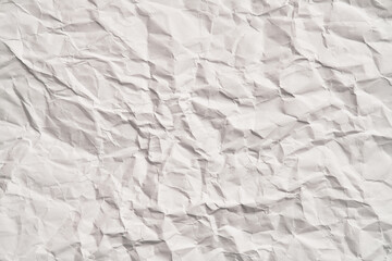 White crumpled paper texture with wrinkles. Damaged and torn sheet