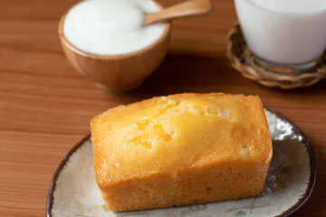 Orange cake with fresh milk on wooden floor