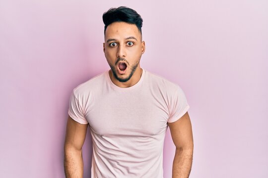 Young arab man wearing casual clothes afraid and shocked with surprise expression, fear and excited face.