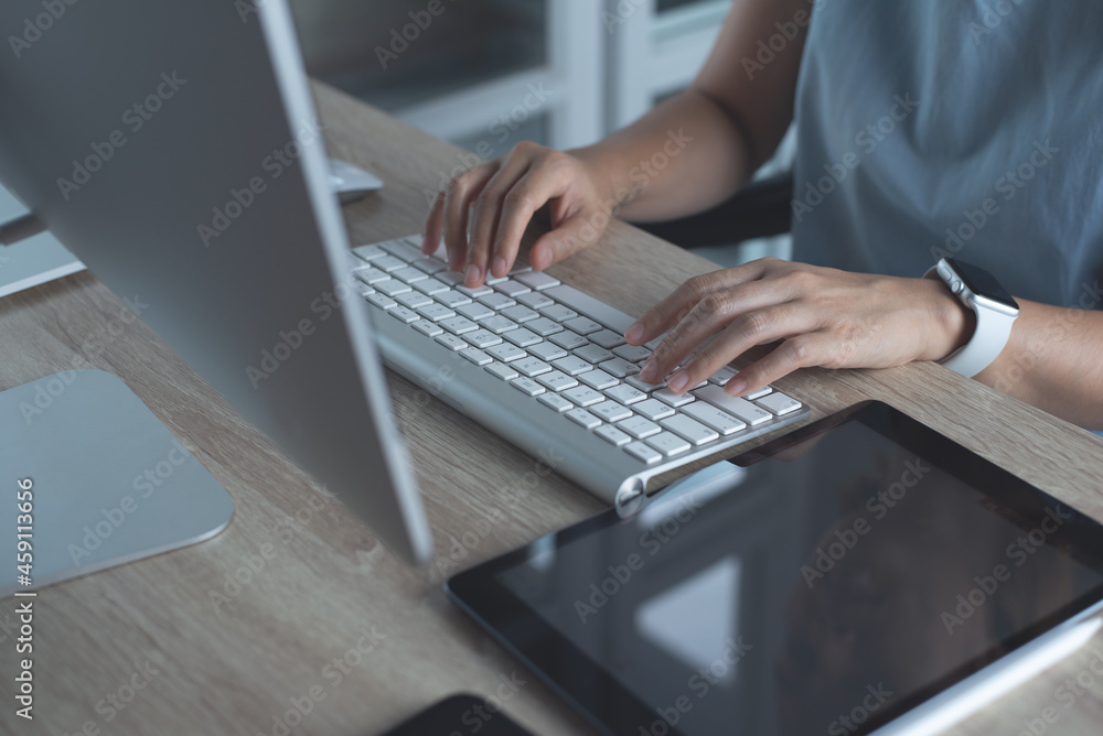 Wall mural close up, woman hands typing, working on desktop computer keyboard with digital tablet and mobile ph