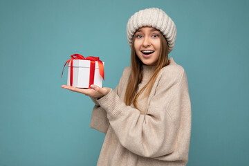 Photo shot of pretty positive surprised young dark blond woman isolated over colourful background...