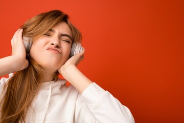 Portrait photo shot of attractive emotional positive young blonde woman wearing white hoodie...