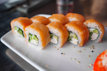 a set of Philadelphia rolls on a white plate. Japanese cuisine. 