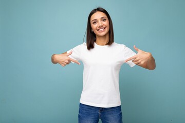 Portrait of positive happy smiling young beautiful brunette woman with sincere emotions wearing...