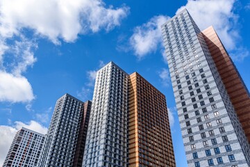 Fototapeta na wymiar View of multi-storey high-rise buildings, beautiful sky on a sunny spring day.