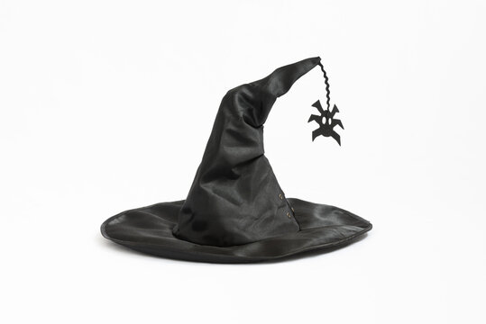 Black witch hat. Hat on a white background. A spider is attached to the hat. Witchcraft and magic. Concept