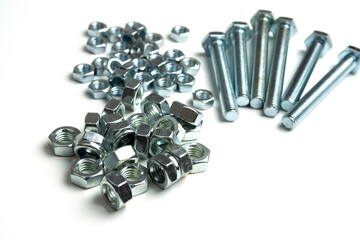 large group of bolts and nuts on a white background. copy space
