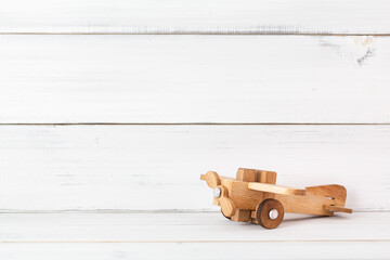Wooden plane on white wood background, education concept.