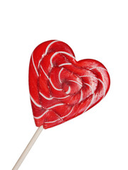 Christmas candy lollipop in the shape of a heart on a wooden stick. Isolated on a white background, close-up